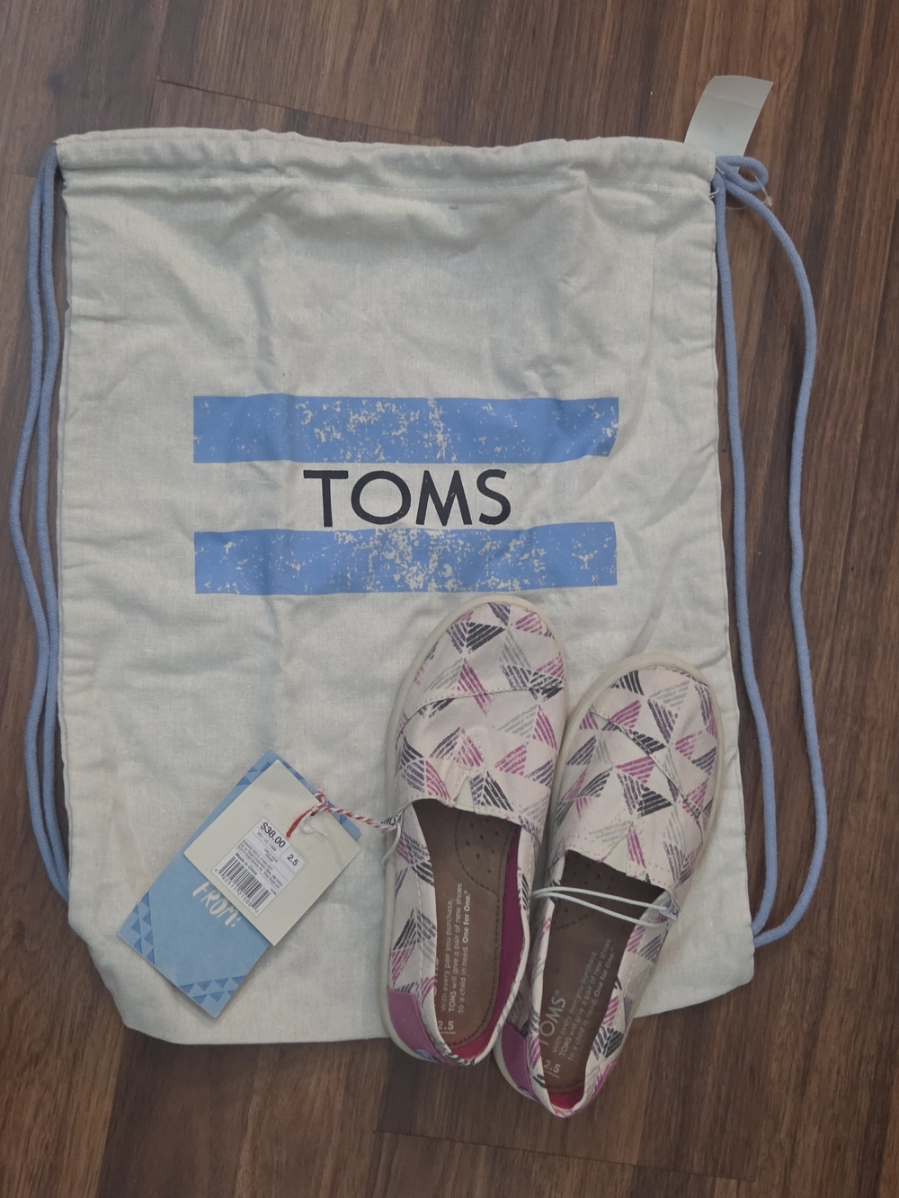 TOMS Women's Canvas Slip-On Shoes in White with Pink & Black Geometric Pattern